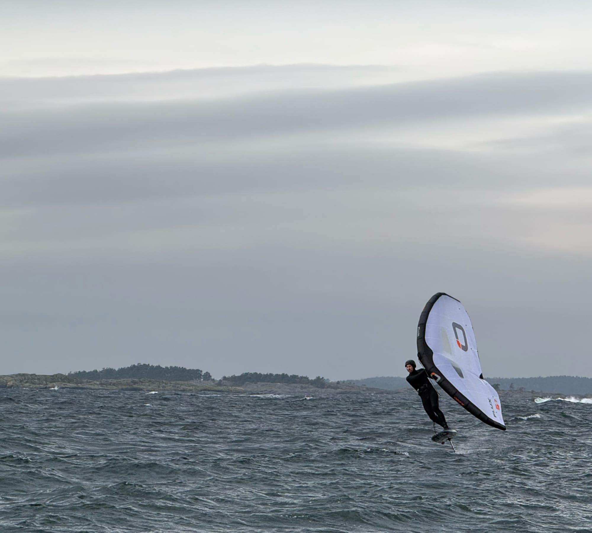 Person wing foiling toe-side — Foil Sessions background image