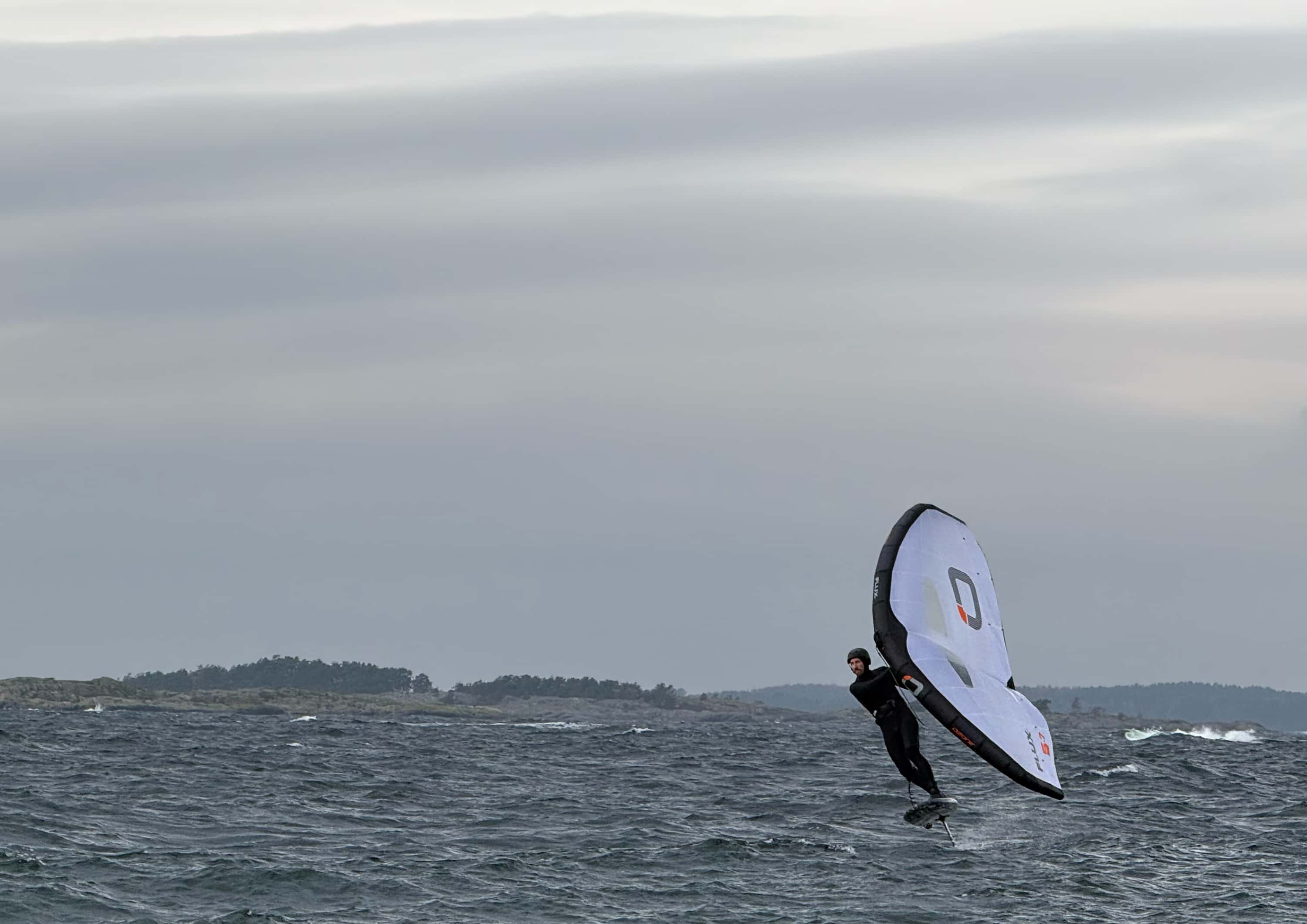 Person wing foiling toe-side — Foil Sessions background image